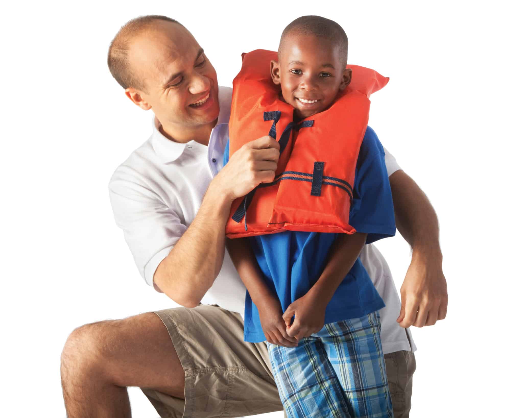 YMCA instructor teaching water safety to young boy..